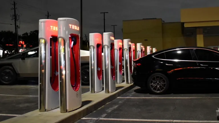 Electric vehicle plugged into a fast charger at a public charging station