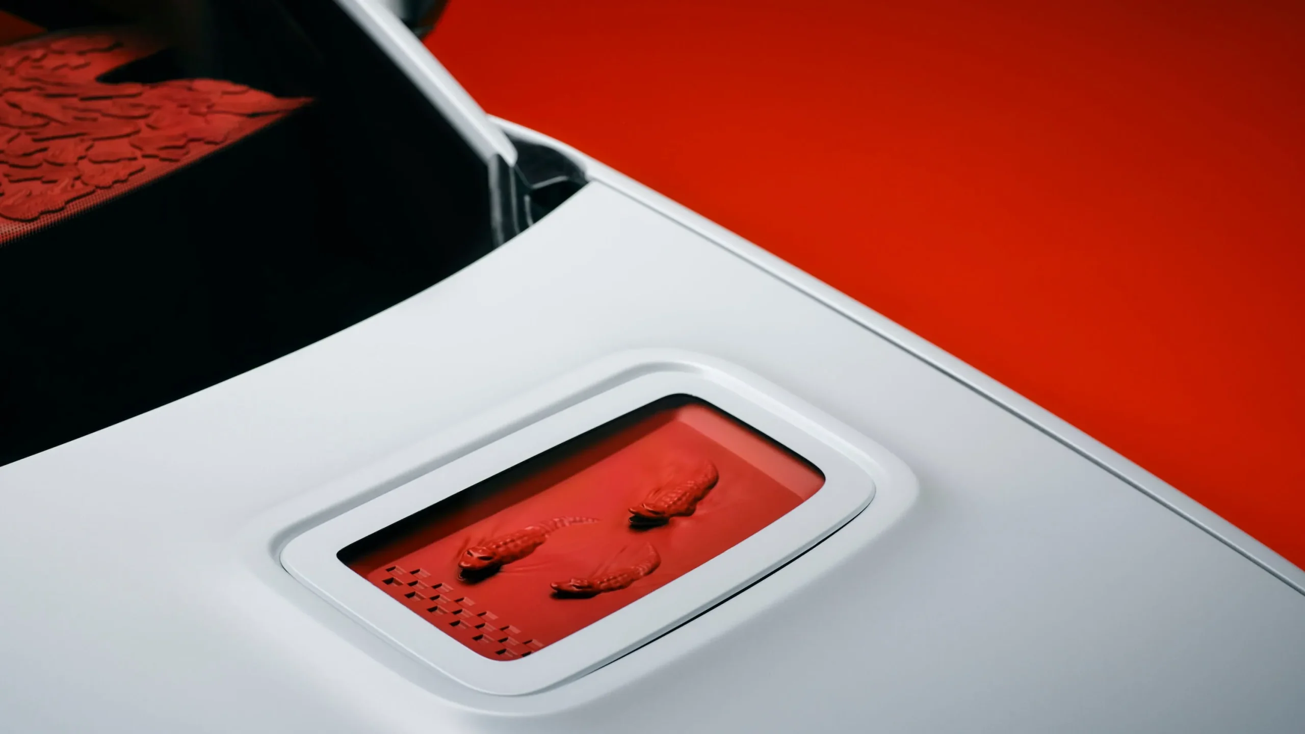 The Alpine A290 Lacoste Rallye electric hot hatch featuring a matte white exterior and red crocodile design details on the