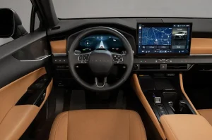 The redesigned tan and black interior cabin of the 2027 Lexus NX Hybrid showing the digital cluster and leather seats.