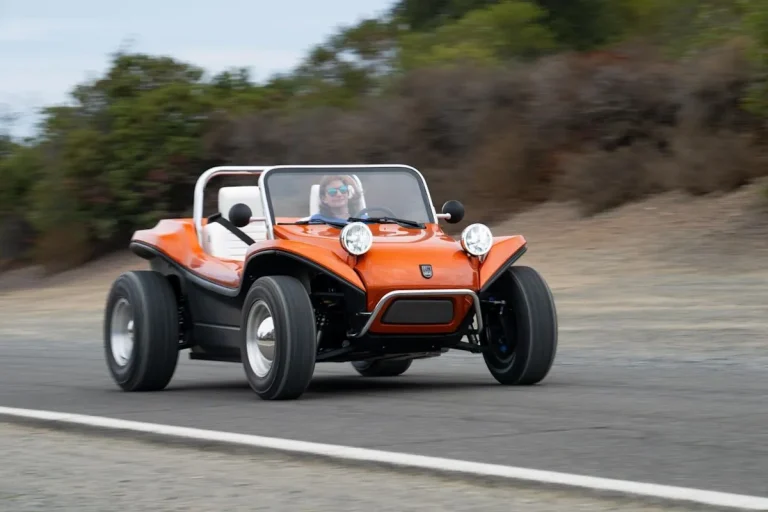 Electric Meyers Manx 2.0 driving on a scenic road