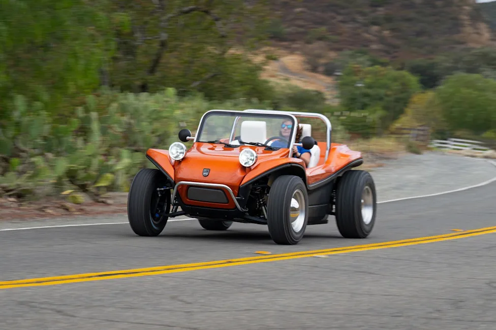 Electric Meyers Manx 2.0 driving on a scenic road
