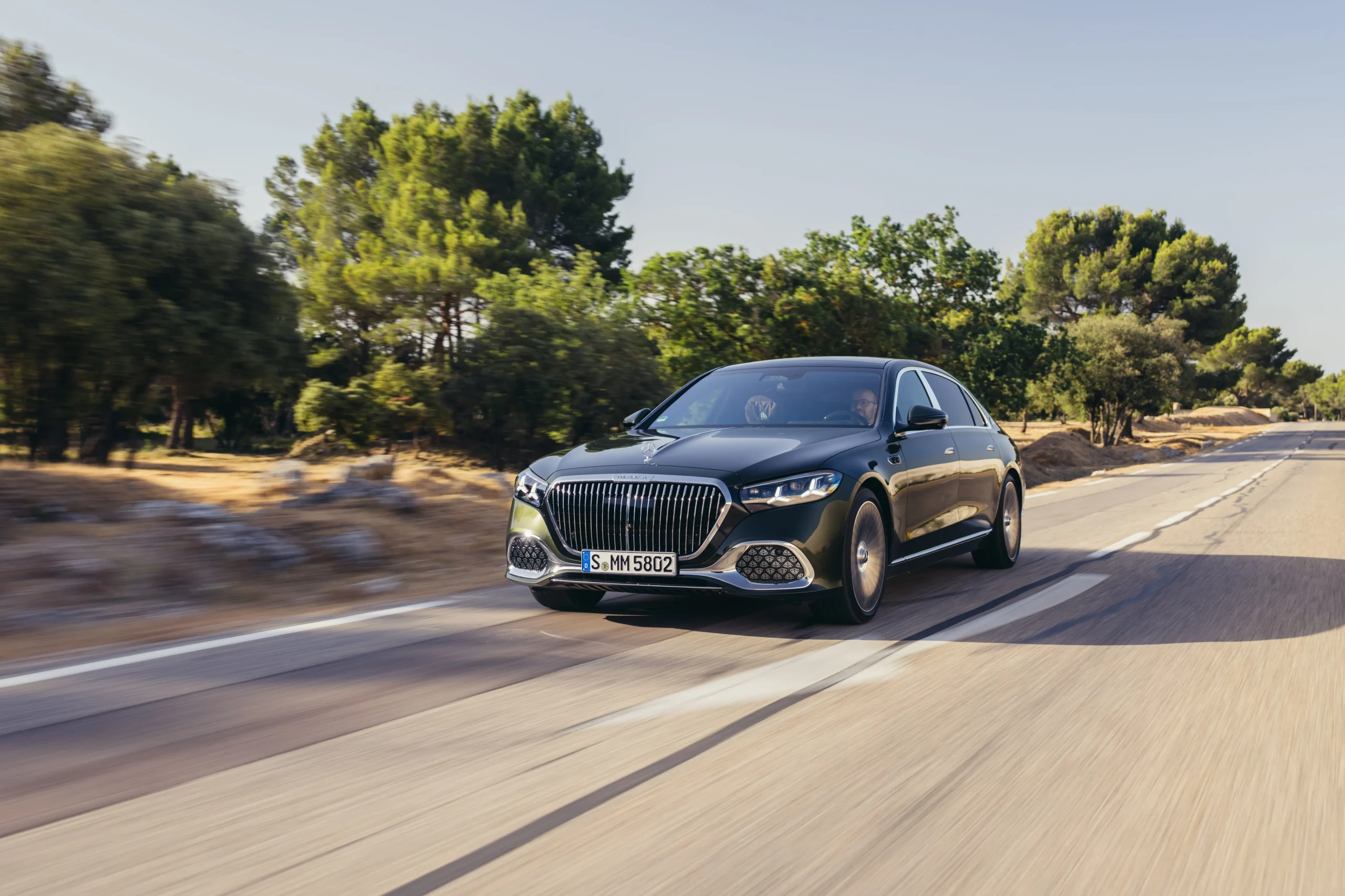 The 2027 Mercedes-Maybach S580 luxury sedan parked on a scenic road