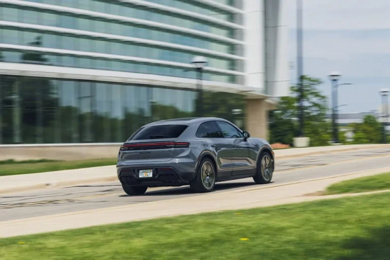 The exterior of the sporty 2026 Porsche Macan GTS Electric featuring distinctive black accents and a lowered stance.