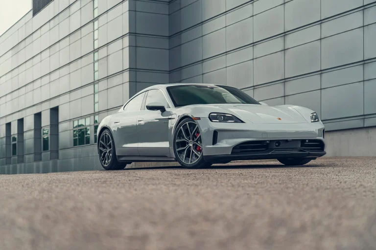 Volkswagen and Porsche vehicle branding displayed on showroom models
