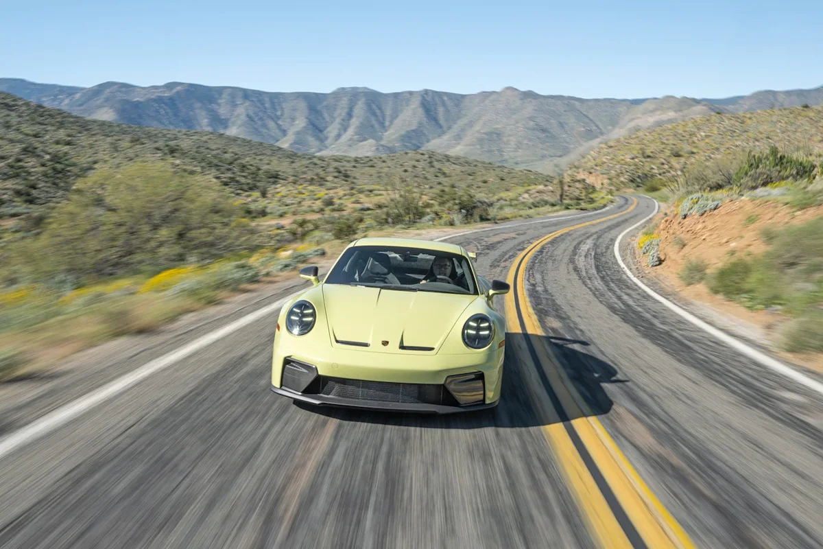 Exterior view of the Cartagena Yellow Metallic 2026 Porsche 911 GT3 showing its prominent rear wing.