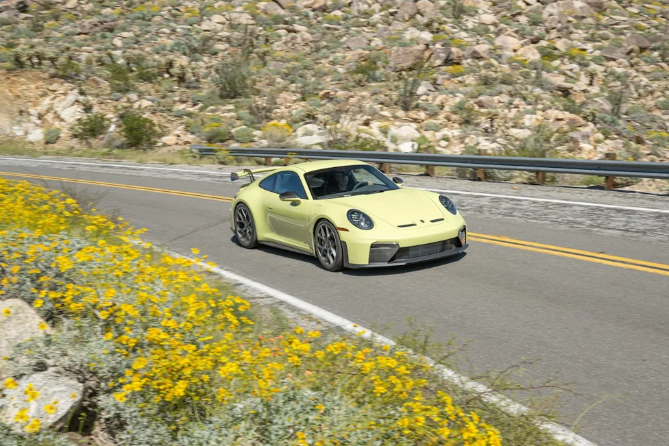 Exterior view of the Cartagena Yellow Metallic 2026 Porsche 911 GT3 showing its prominent rear wing.
