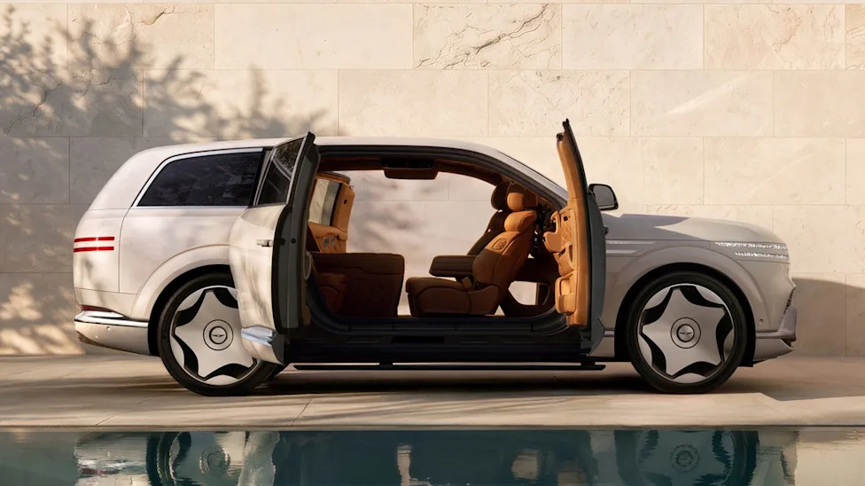 The side profile of the 2027 Genesis GV90 showing its innovative pillarless coach doors open to reveal a luxurious cabin.