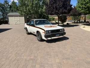 A 1979 AMC Spirit AMX V8 classic muscle car with hood decals and alloy wheels
