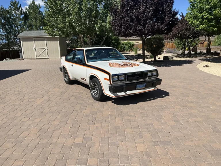 A 1979 AMC Spirit AMX V8 classic muscle car with hood decals and alloy wheels
