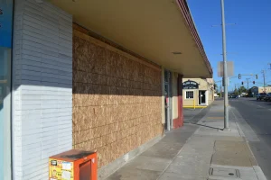Boarded-up storefront of the 98 Cents Store in Watsonville after a vehicle crash.