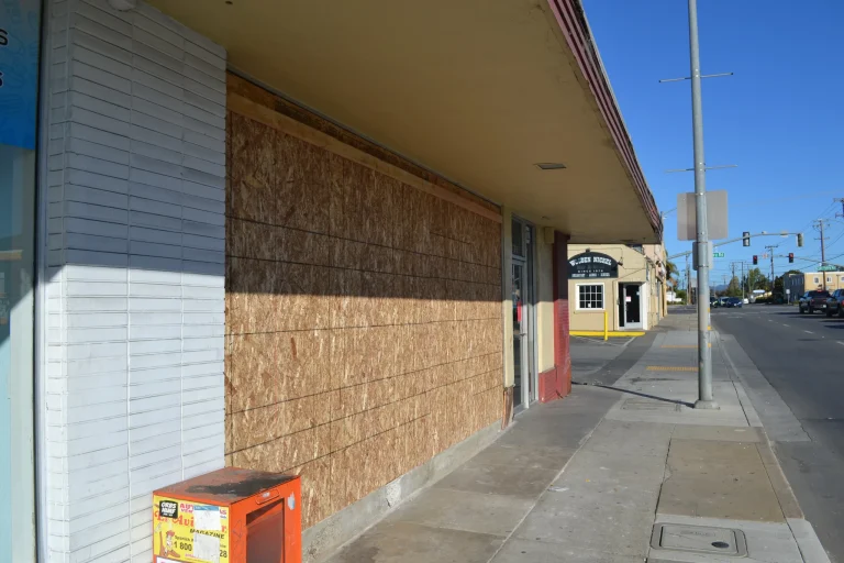 Boarded-up storefront of the 98 Cents Store in Watsonville after a vehicle crash.