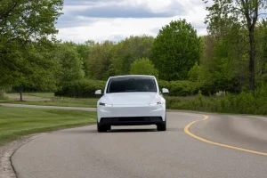 Rear-wheel-drive Tesla Model Y in Pearl White paint parked outdoors