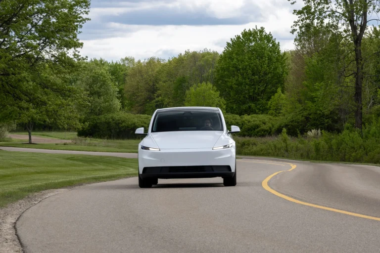 Rear-wheel-drive Tesla Model Y in Pearl White paint parked outdoors