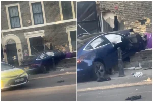 A blue Tesla Model 3 crashed into the brickwork of a Victorian townhouse in Bethnal Green, London