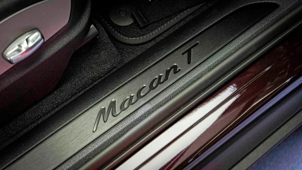 A close-up of a Porsche Macan T finished in Copper Ruby Metallic paint