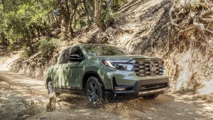 A modern Honda Ridgeline pickup truck driving on an open highway