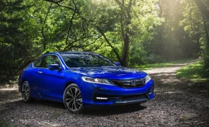 A sleek silver Honda Accord Coupe parked on a scenic road