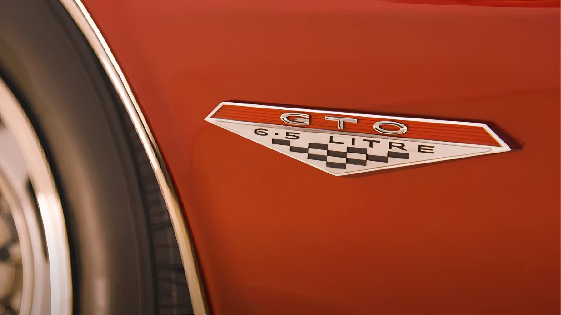 A vintage 1964 Pontiac GTO on a race track