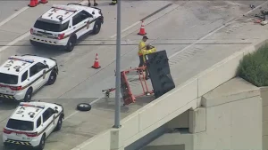 Damaged white SUV and construction arrow board at the scene of an Interstate 95 work zone crash in Philadelphia