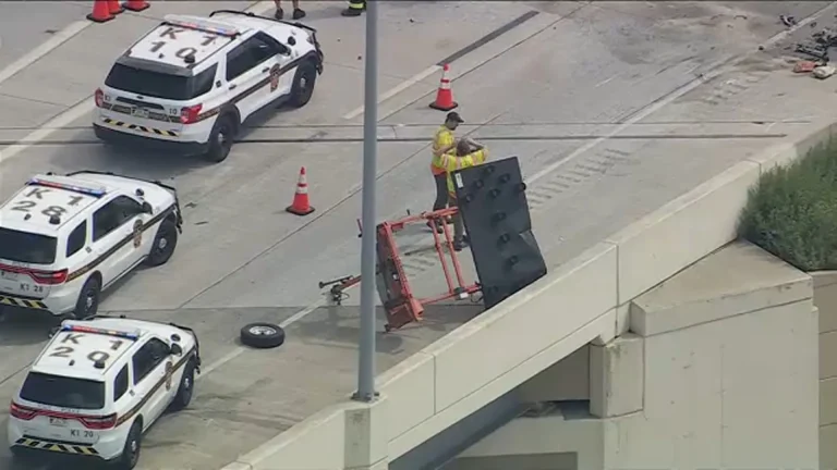 Damaged white SUV and construction arrow board at the scene of an Interstate 95 work zone crash in Philadelphia