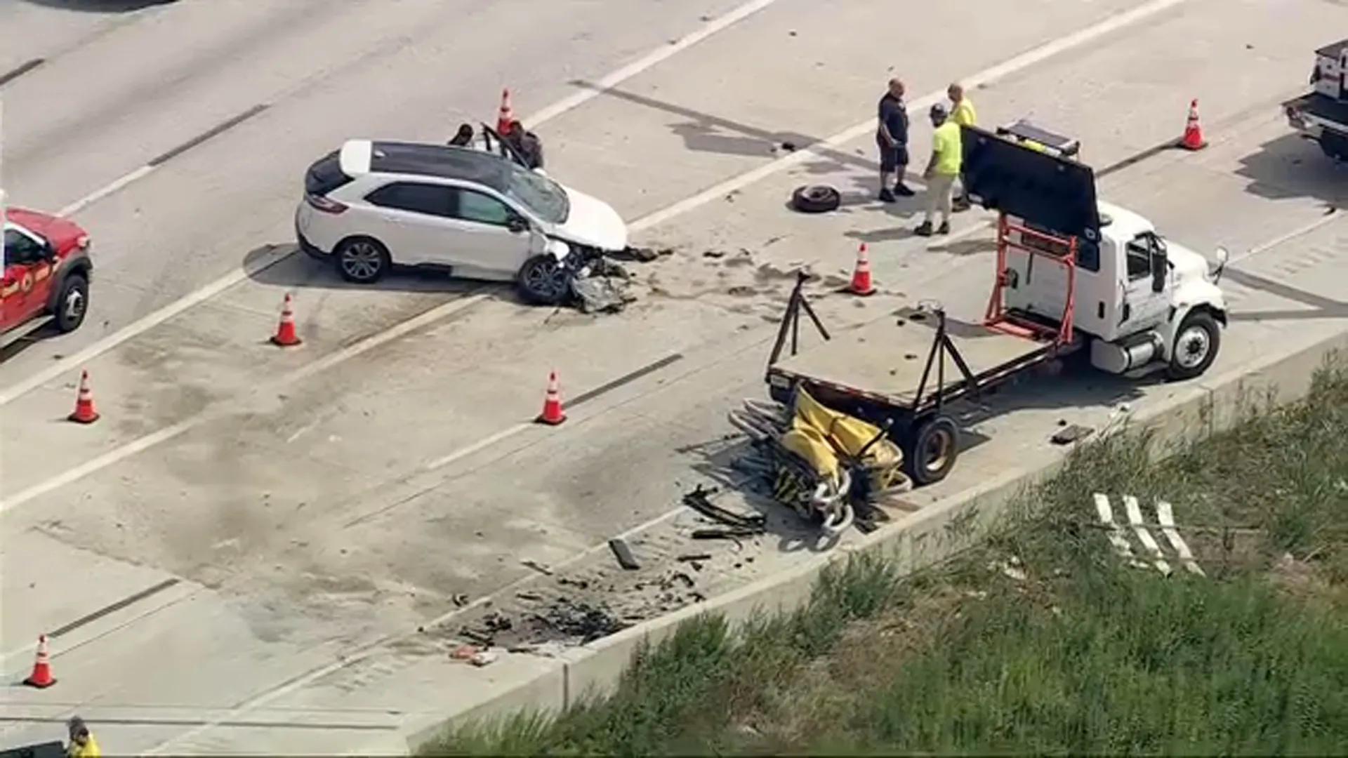 Damaged white SUV and construction arrow board at the scene of an Interstate 95 work zone crash in Philadelphia