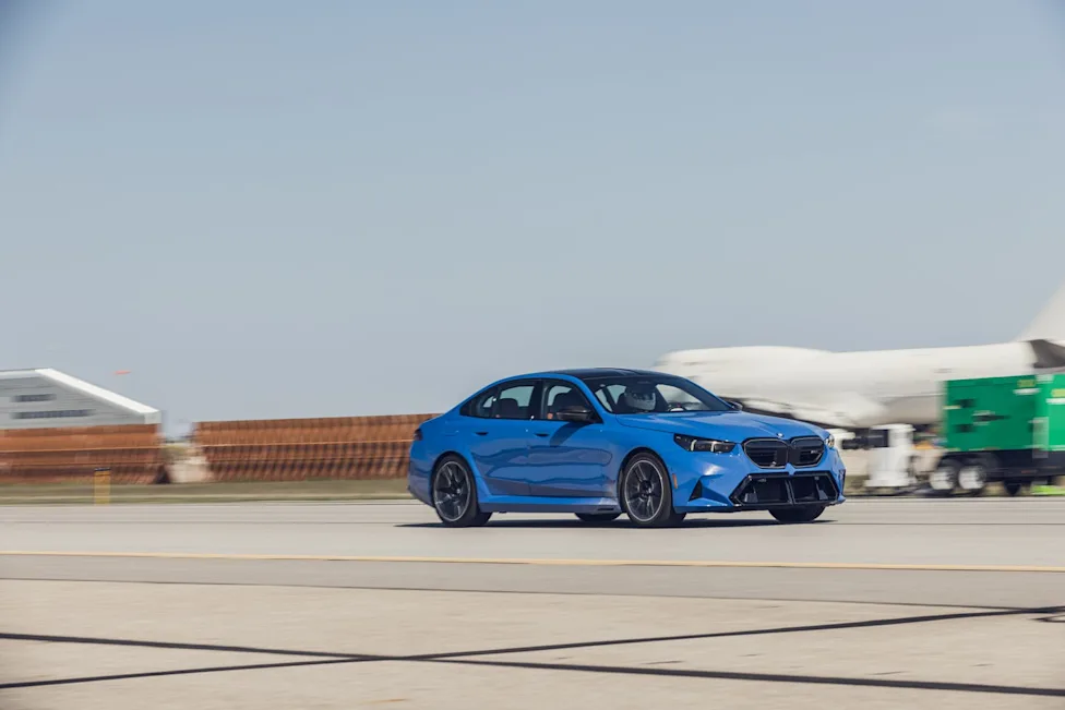 The 2026 BMW M5 performing a high-speed brake test on a track.