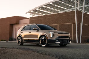 The front profile of the redesigned 2027 Kia Niro subcompact hybrid SUV in Sunset Beige