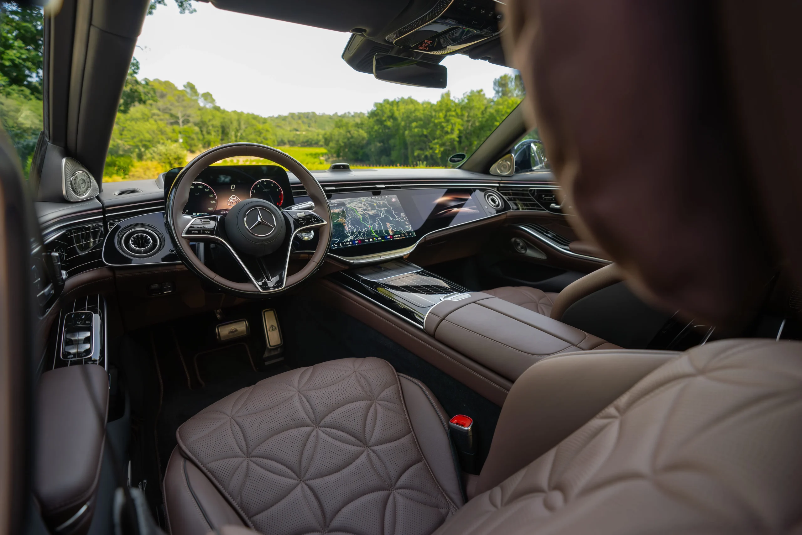 The front profile of the redesigned 2027 Mercedes-Maybach S-Class luxury sedan highlighting its larger illuminated grille