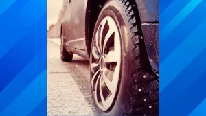 A close-up of a car tire on an open highway representing rolling resistance and fuel efficiency.