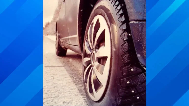 A close-up of a car tire on an open highway representing rolling resistance and fuel efficiency.