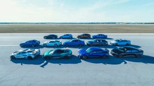 A collection of high-performance vehicles participating in a speed and braking test at Oscoda-Wurtsmith Airport.