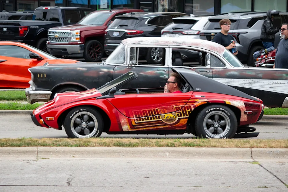 A collection of unique and unusual custom vehicles driving down Woodward Avenue during the Dream Cruise event.