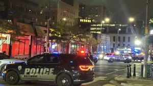 Police vehicles gathered at North Eutaw Street in Baltimore following an officer-involved shooting.
