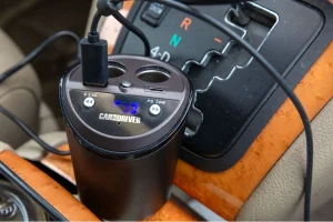 The Car and Driver Smart FM Transmitter placed inside a car cupholder