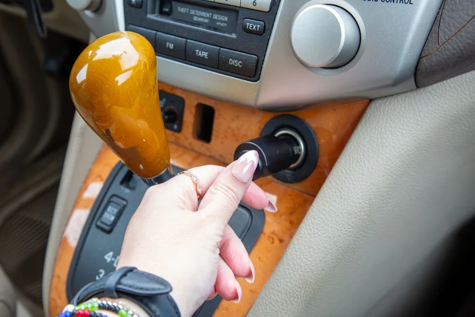 The Car and Driver Smart FM Transmitter placed inside a car cupholder
