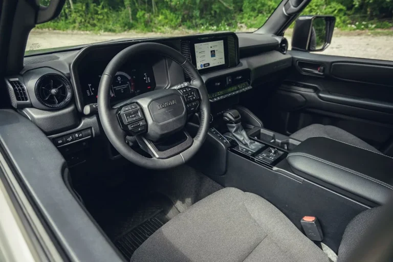 The retro-inspired dashboard and physical controls of the 2026 Toyota Land Cruiser 1958 interior