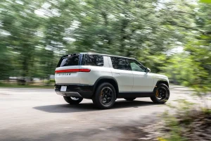 The Rivian R2 Performance SUV showcased on an open road, highlighting its signature dual-oval headlights and boxy design