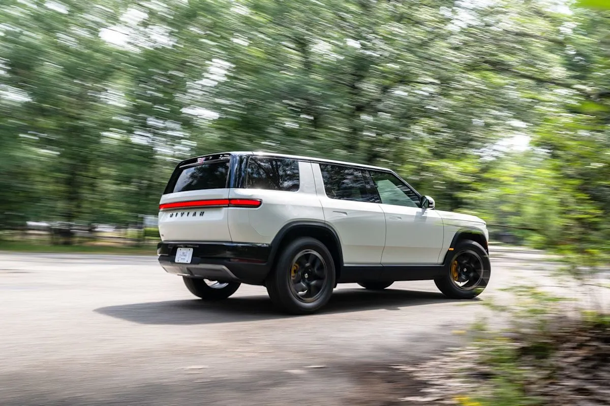 The Rivian R2 Performance SUV showcased on an open road, highlighting its signature dual-oval headlights and boxy design