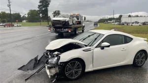 Two sedans collide on Hawkinsville Road, overturning one vehicle and injuring a driver