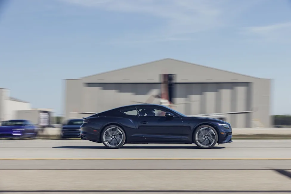 A luxury Bentley Continental GT S performing a high-speed acceleration and braking test.