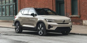 The exterior view of a Volvo EX40 electric compact luxury SUV parked on a city street.